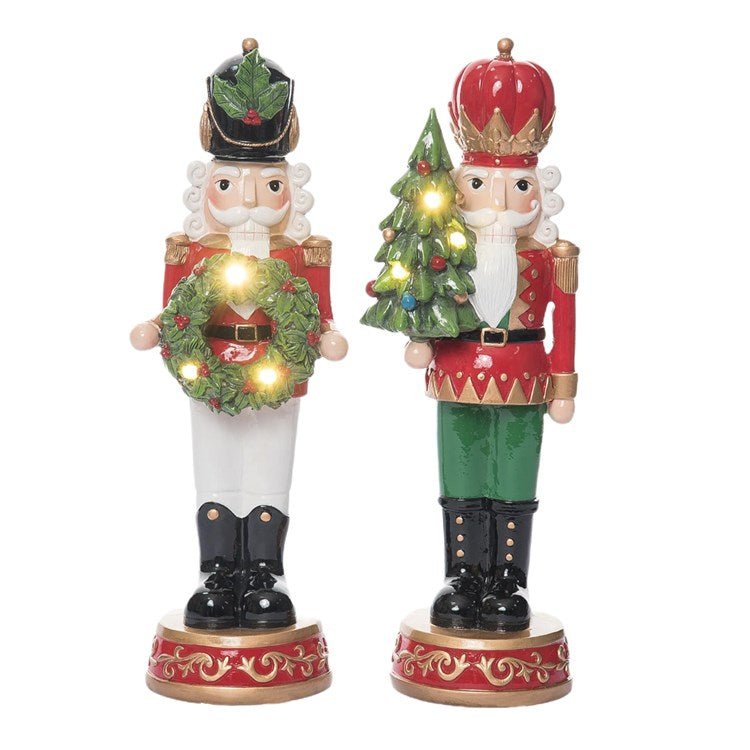 Two decorative nutcrackers with Christmas-themed outfits on a white background