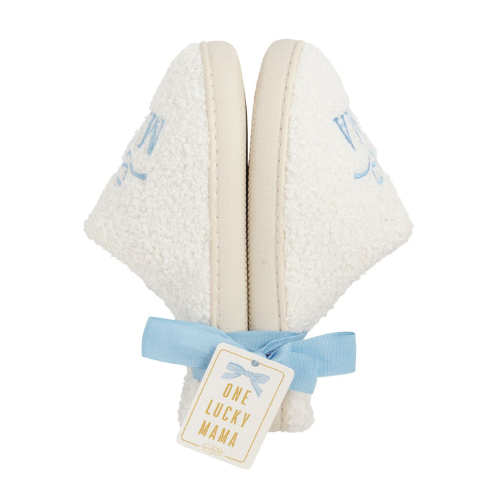 Pair of white slippers with blue accents and a 'One Lucky Mama' tag on a white background