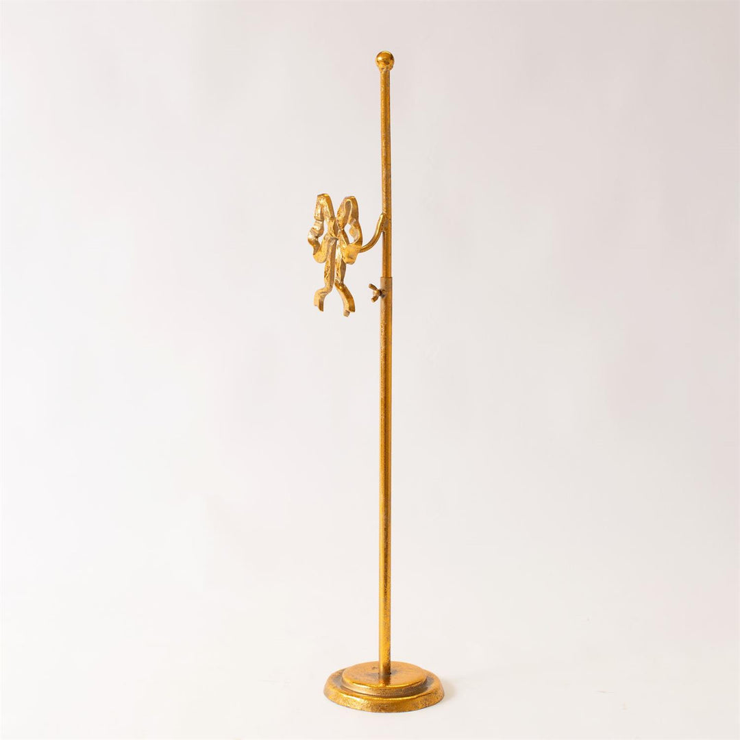 Gold wreath stand with bow design on a white background