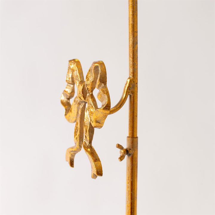 Gold bow-shaped hook on a white background