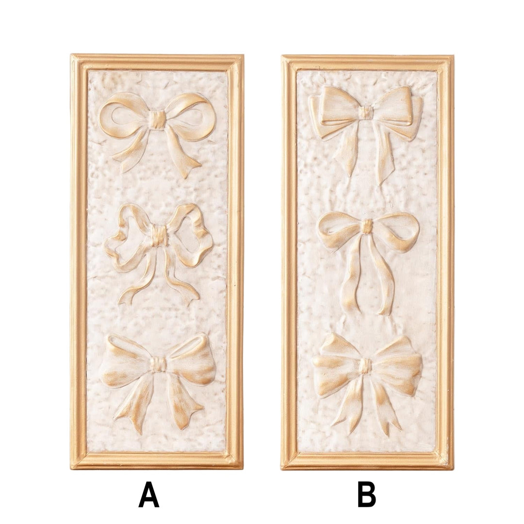 Two decorative wall panels with bow designs on a white background