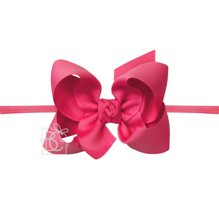 Pink hair bow on a white background