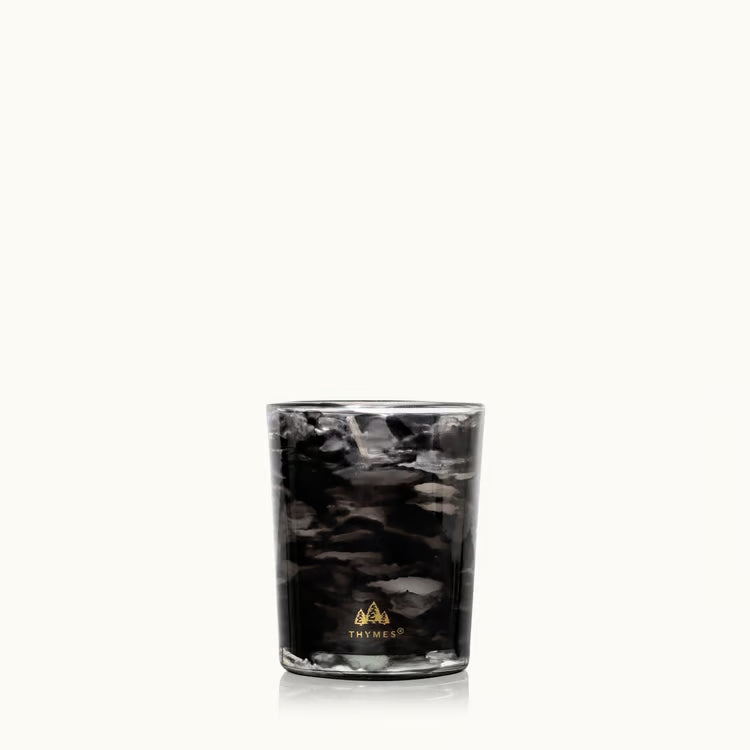 Noir Woods votive candle styled with smoky woodland accents