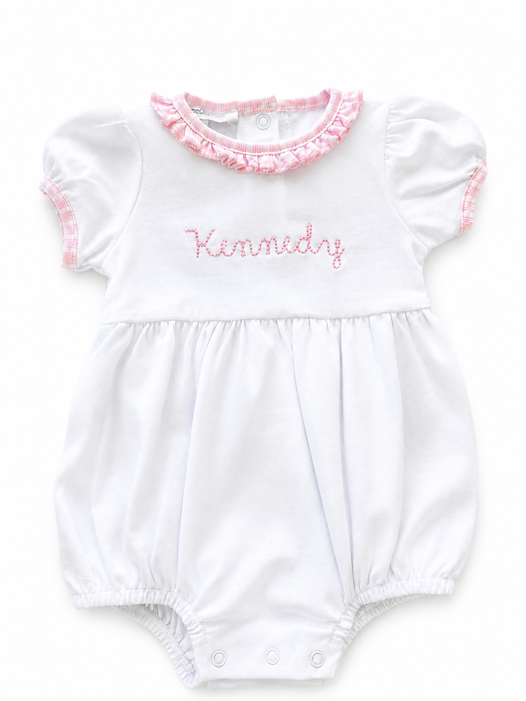 White baby romper with pink ruffled collar and embroidered name on a white background