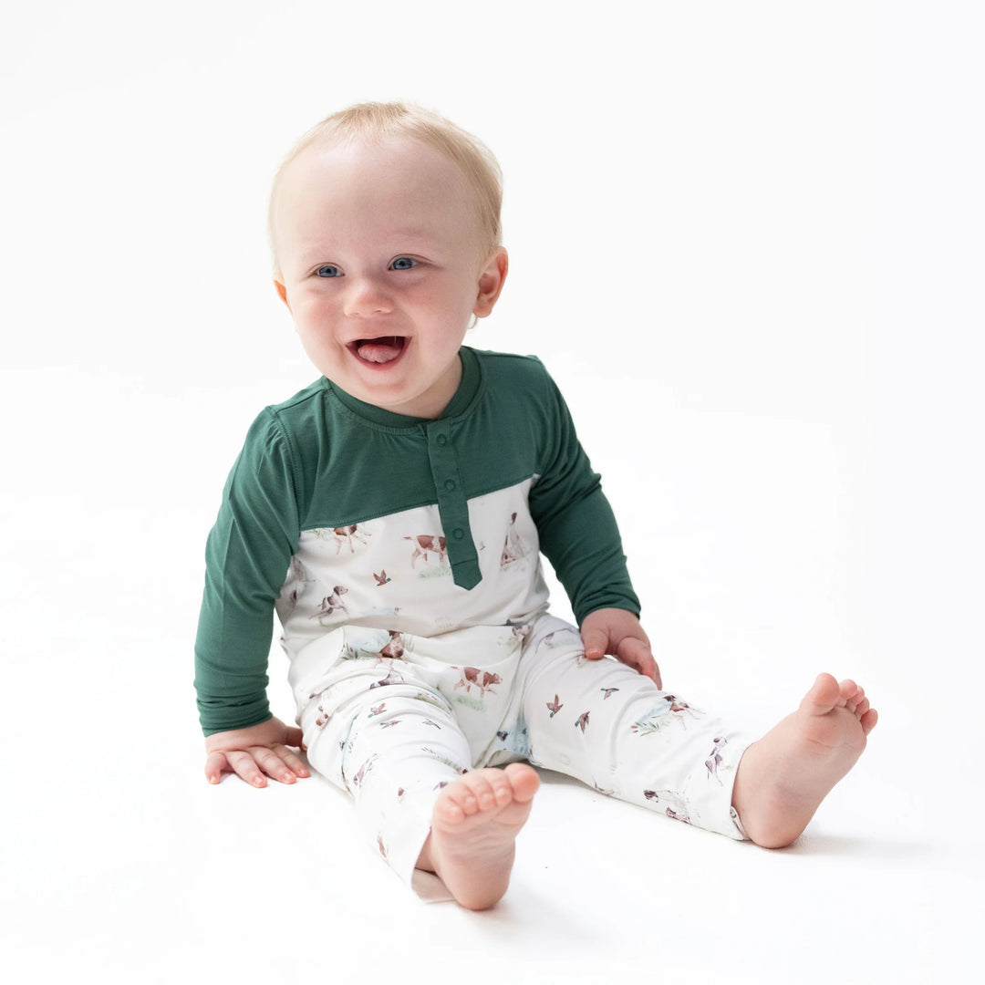 Angel Dear Pointer Pups and Duck Buddies Romper with Contrast Sleeves worn by a baby in a lifestyle view highlighting the pointer pups and duck buddies with contrast sleeves design