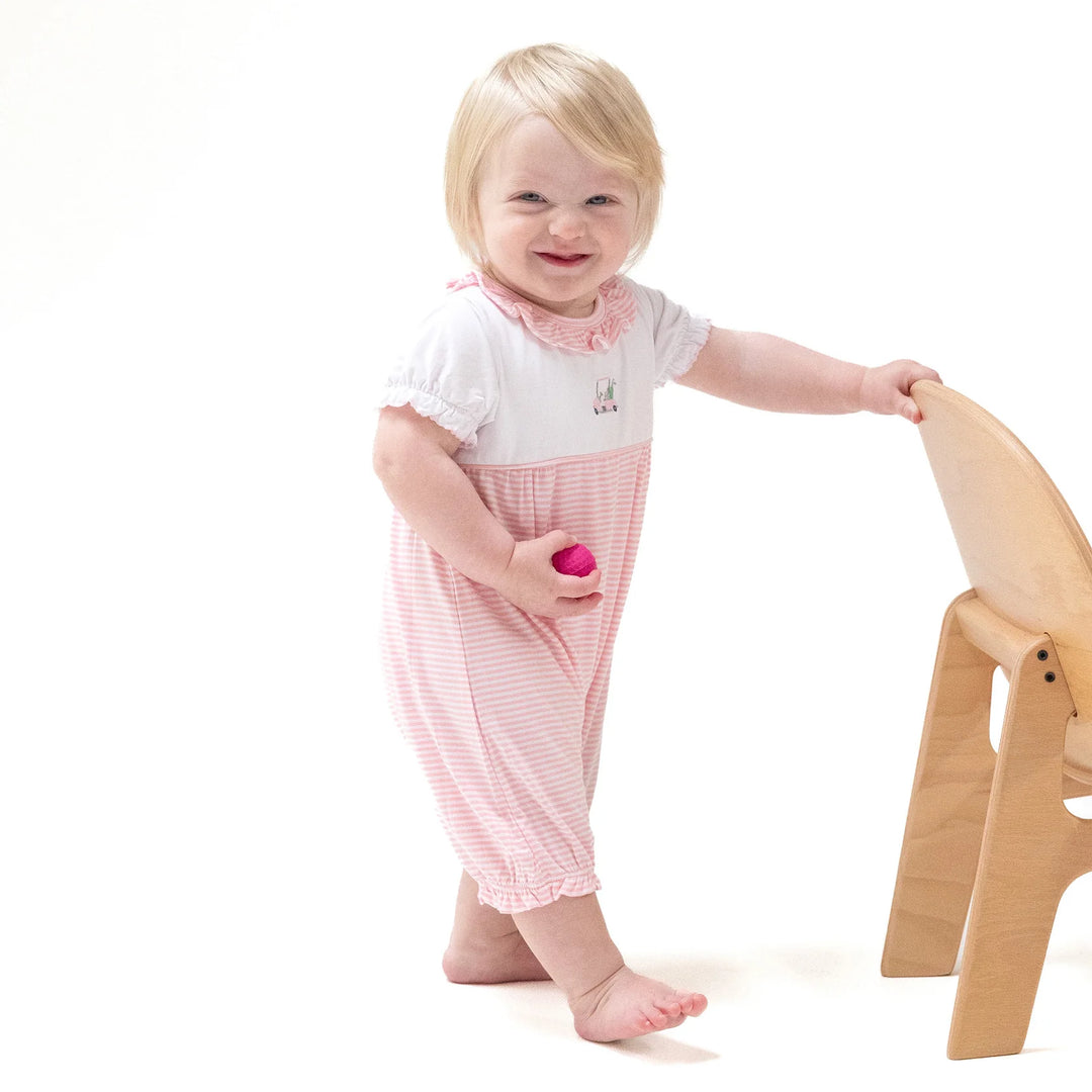baby girl in pink golf carts romper