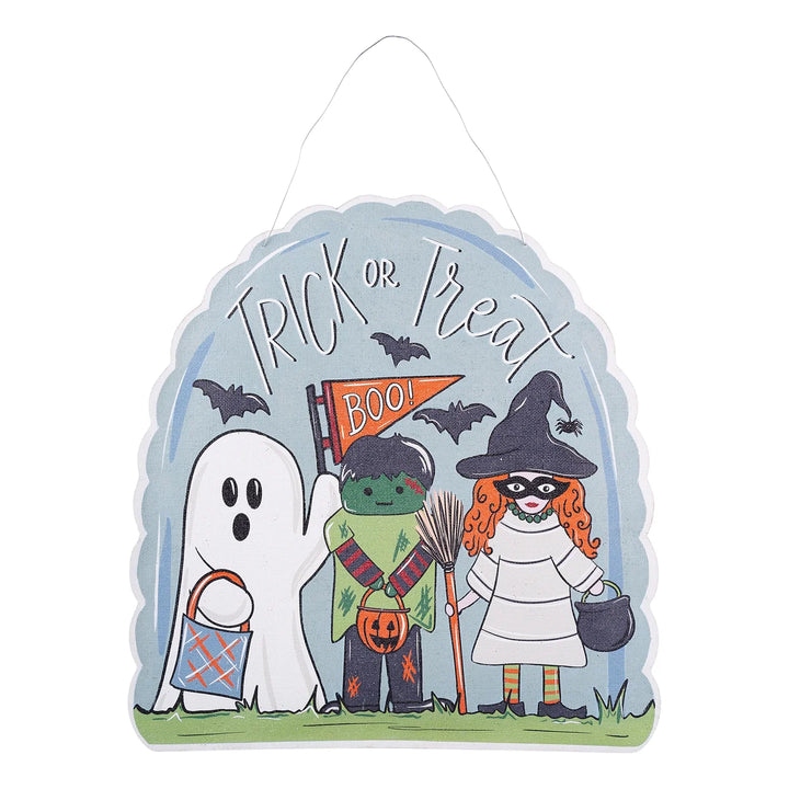 A scalloped Halloween decorative sign with a hanging loop, featuring cartoon characters including a ghost, a green monster, a witch with orange hair, bats, and the words “Trick or Treat” on a light blue background.