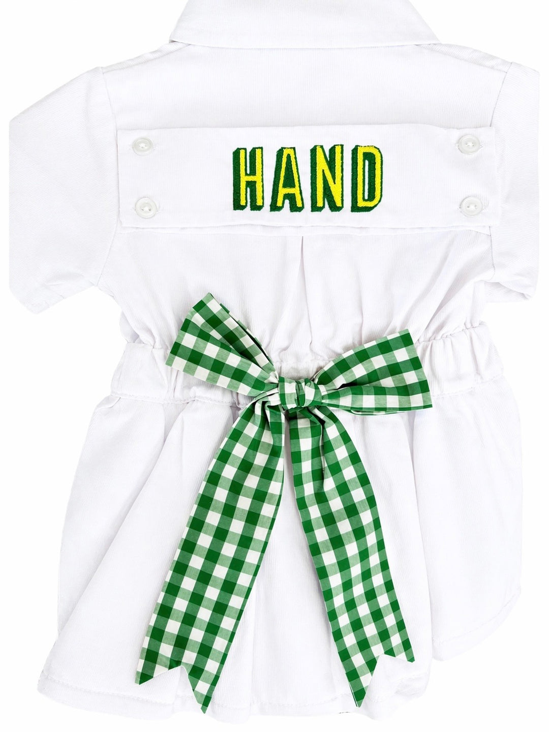White dress with green checkered bow and 'HAND' text on a white background