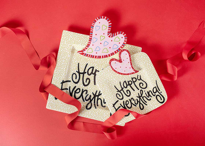 Two decorative cards with heart designs and text on a red background