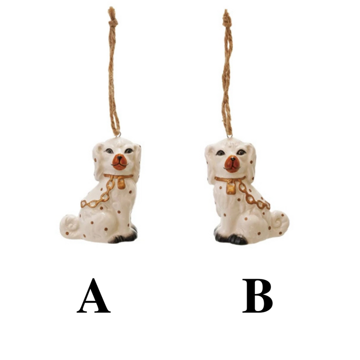 Two ceramic dog ornaments hanging from strings on a white background.
