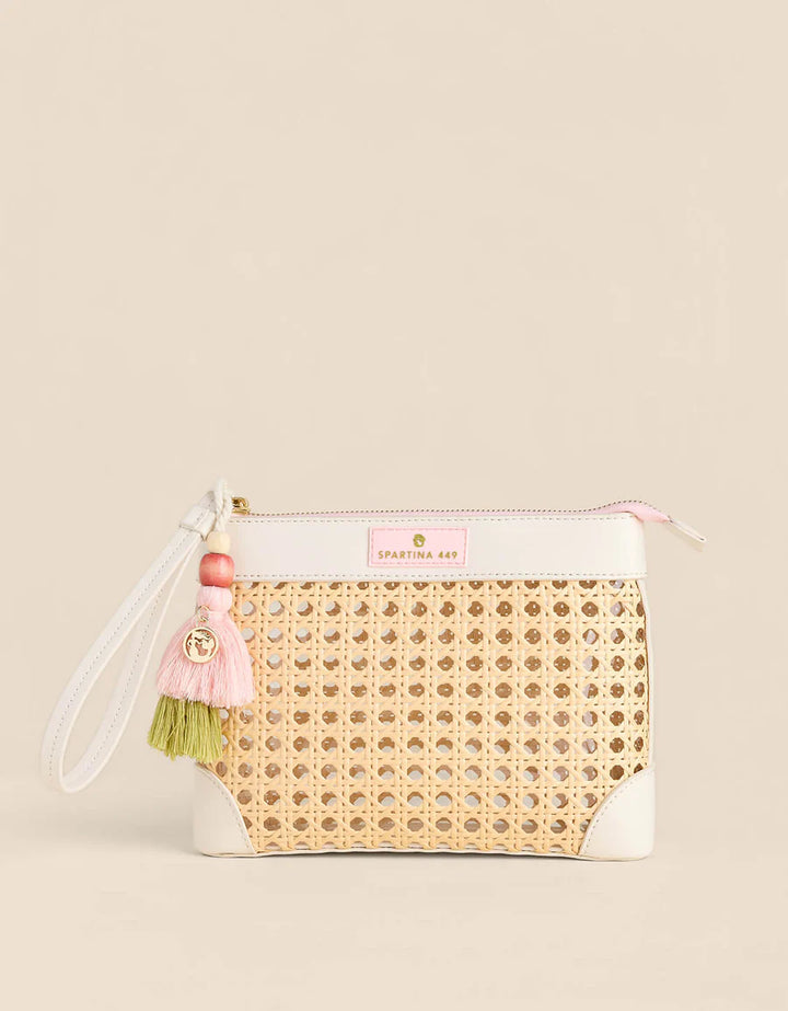 Woven clutch bag with pink accents on a beige background