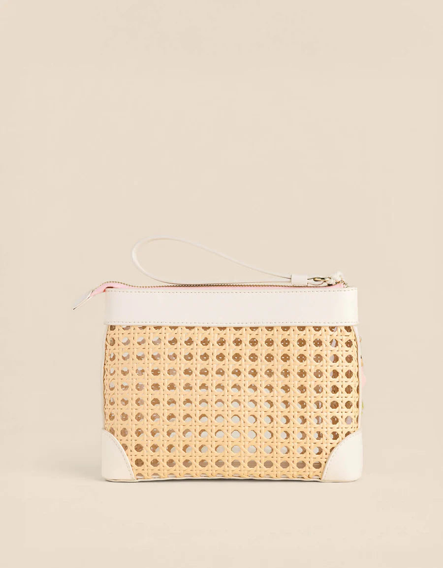 Woven handbag with white accents on a beige background