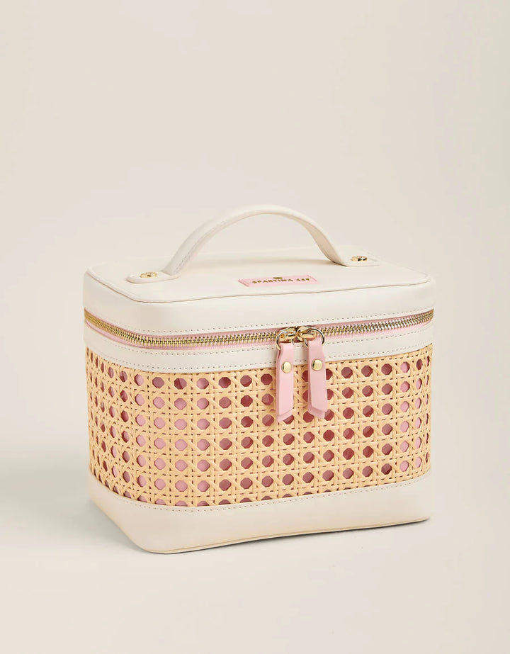 Cosmetic bag with wicker pattern and pink zipper on a beige background