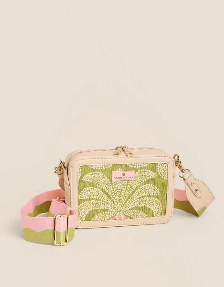 Small handbag with floral pattern and pink strap on a beige background