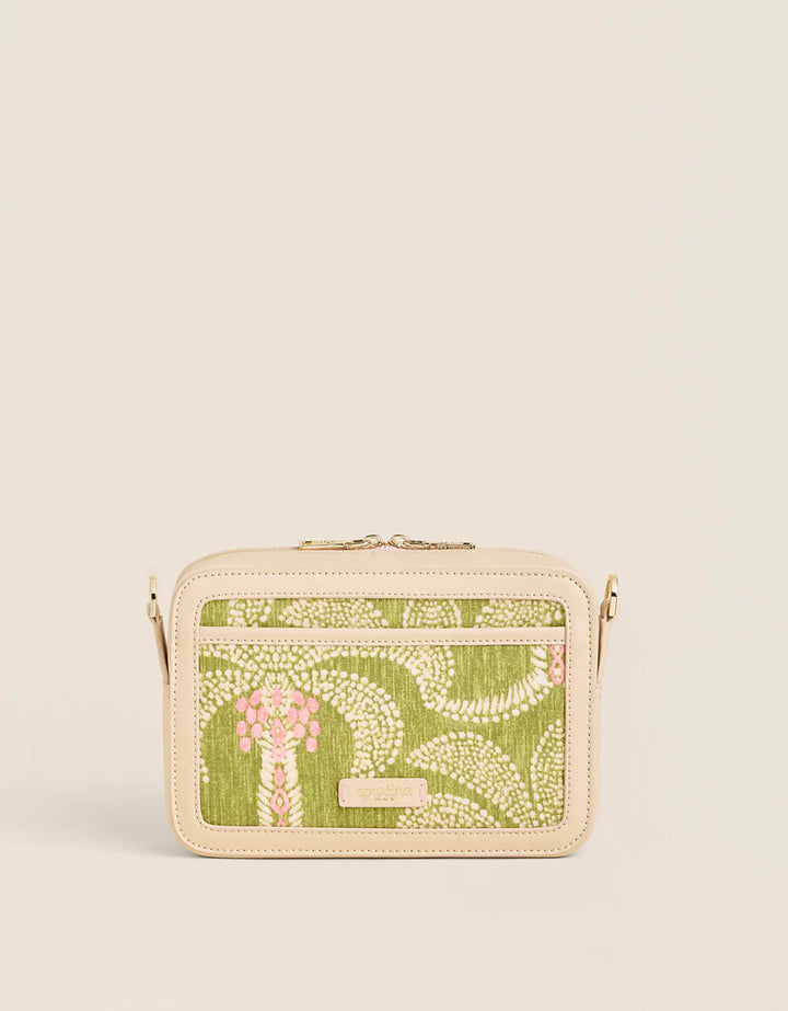 Small handbag with green floral pattern on a beige background