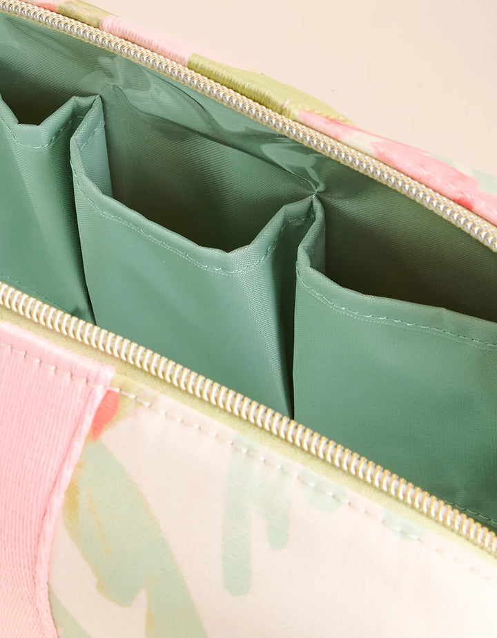 Close-up of a green and pink bag with compartments.