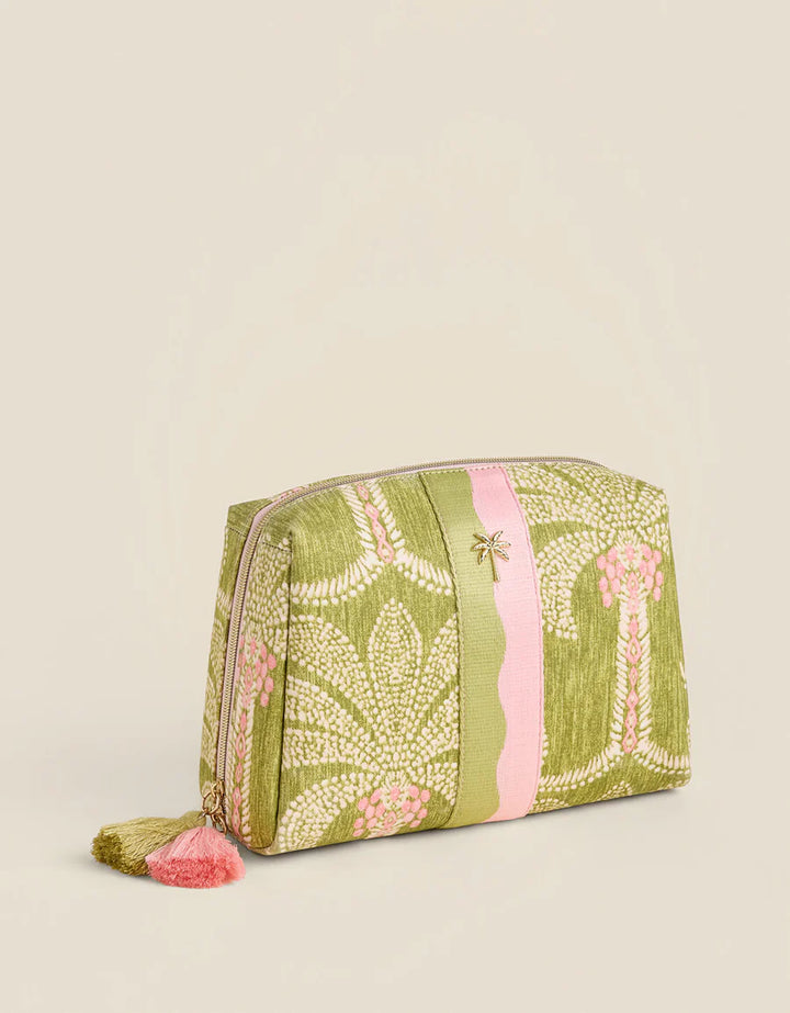 Green patterned pouch with pink accents on a beige background