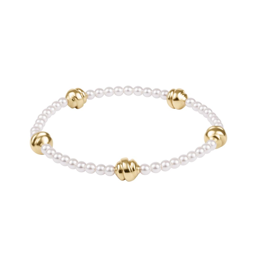 Pearl bracelet with gold beads on a white background