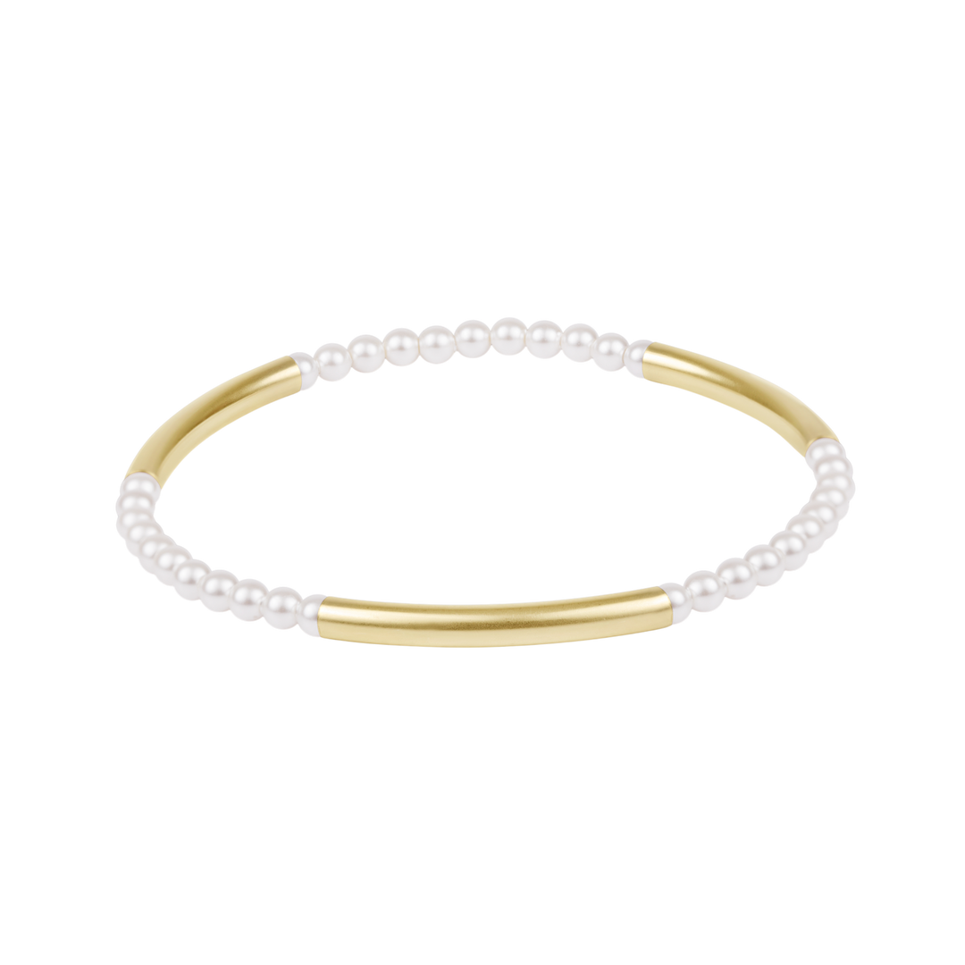 Gold and pearl bracelet on a white background