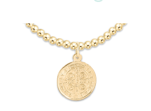 Gold necklace with a round pendant on a white background