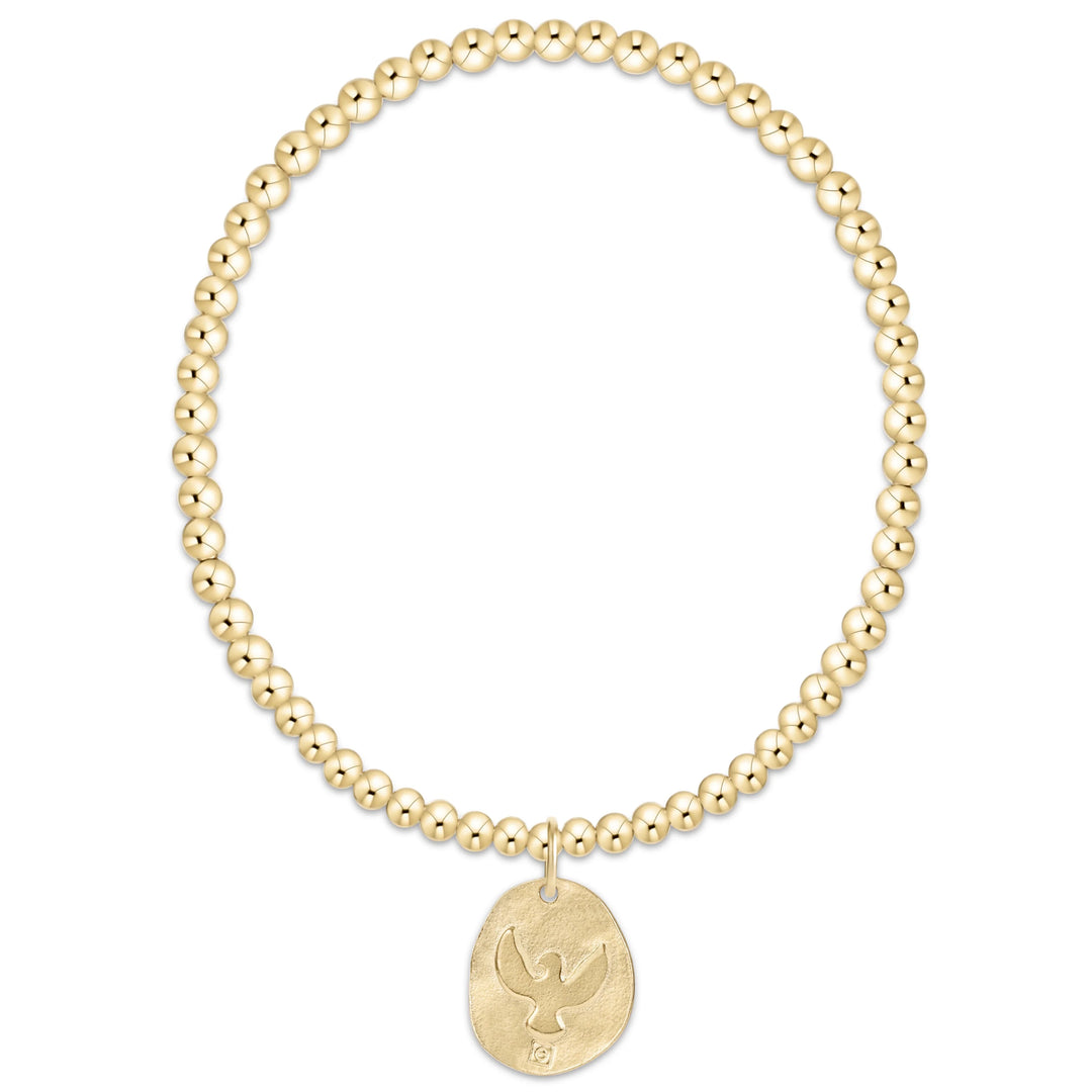 Gold beaded bracelet with a gold eagle embossed pendant on a white background