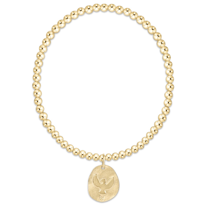 Gold beaded bracelet with a gold eagle embossed pendant on a white background