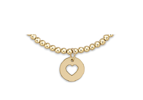 Gold necklace with a heart-shaped pendant on a white background