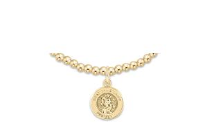 Gold necklace with a round pendant on a white background