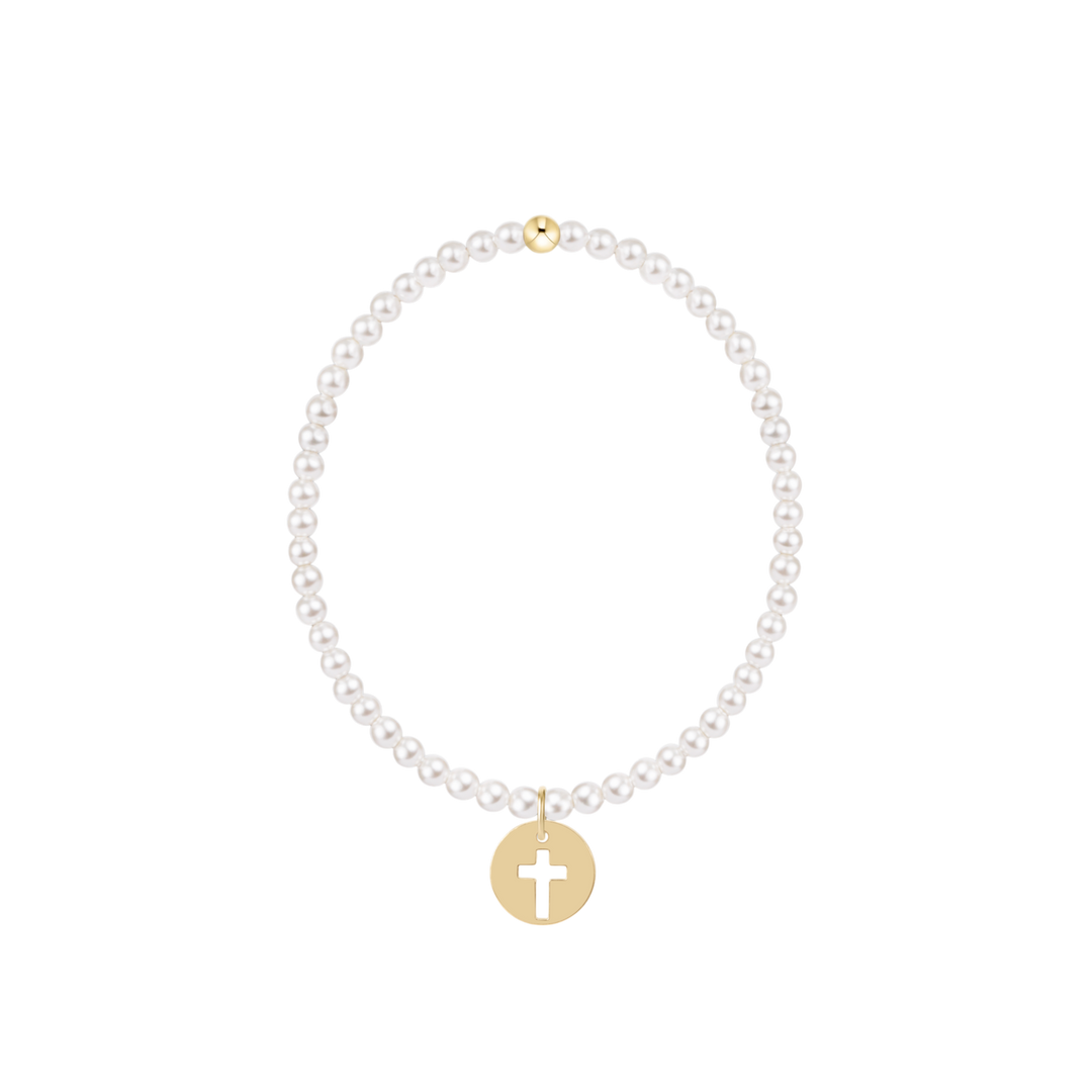 Pearl bracelet with a gold cross charm on a white background