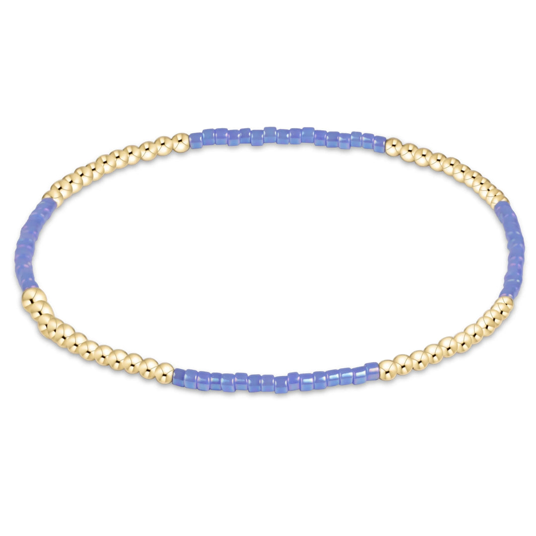 BLUE AND GOLD BEADED BRACELET ON WHITE BACKGROUND