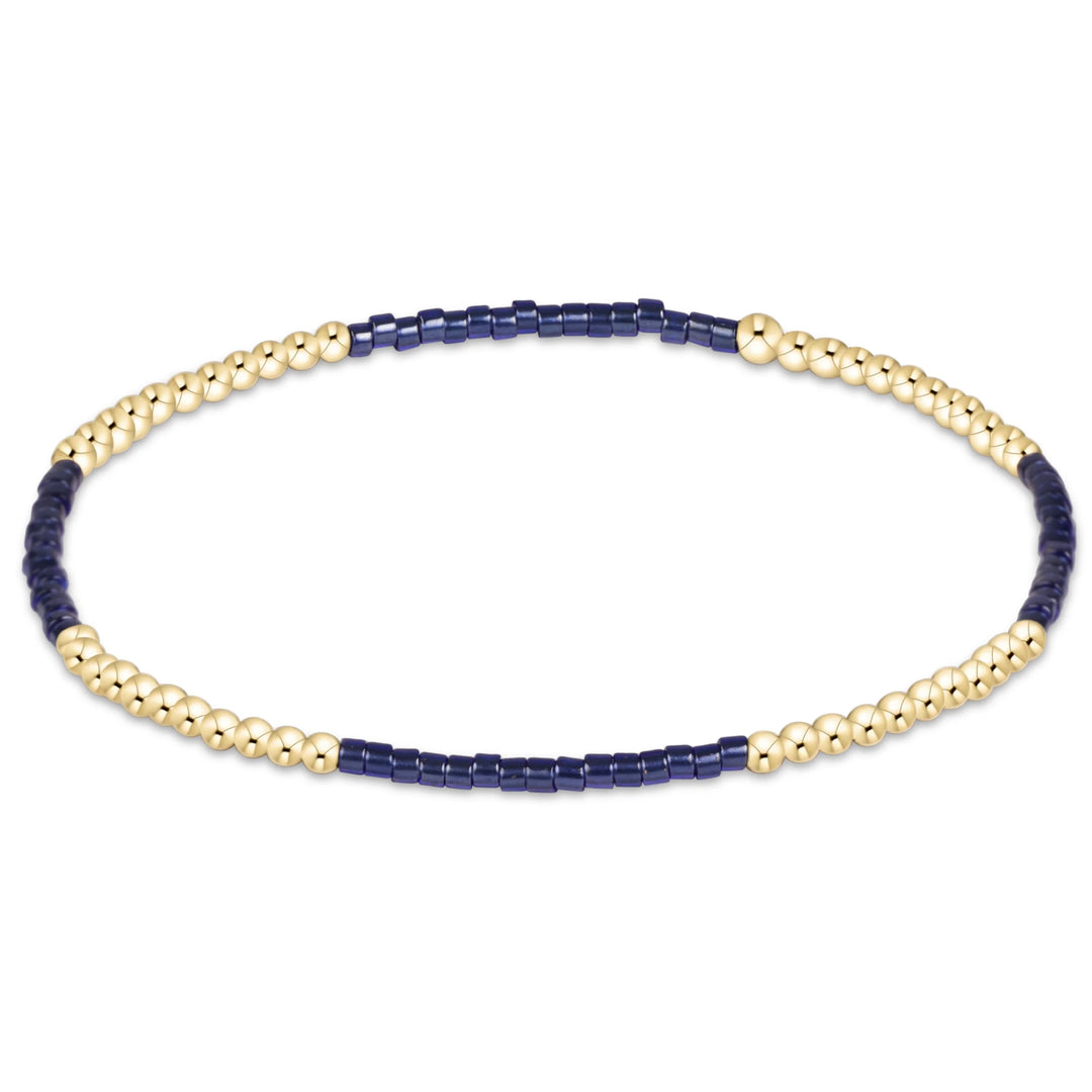 navy and gold beaded bracelet on white background
