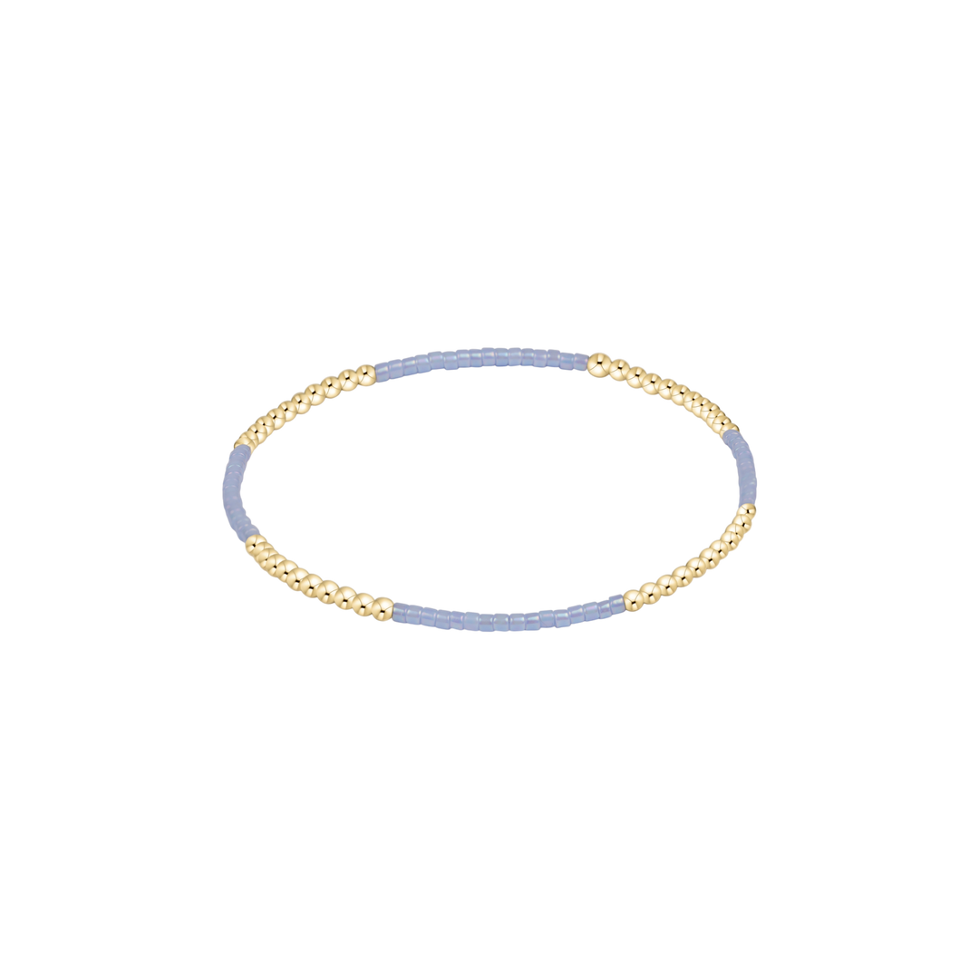 Two-toned gold and blue headband on a white background