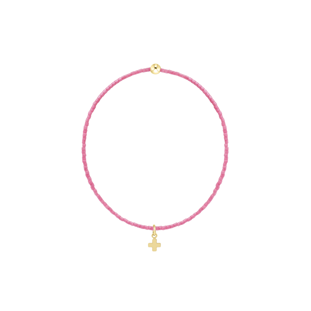 bubblegum pink beaded bracelet with gold accent bead and gold cross charm