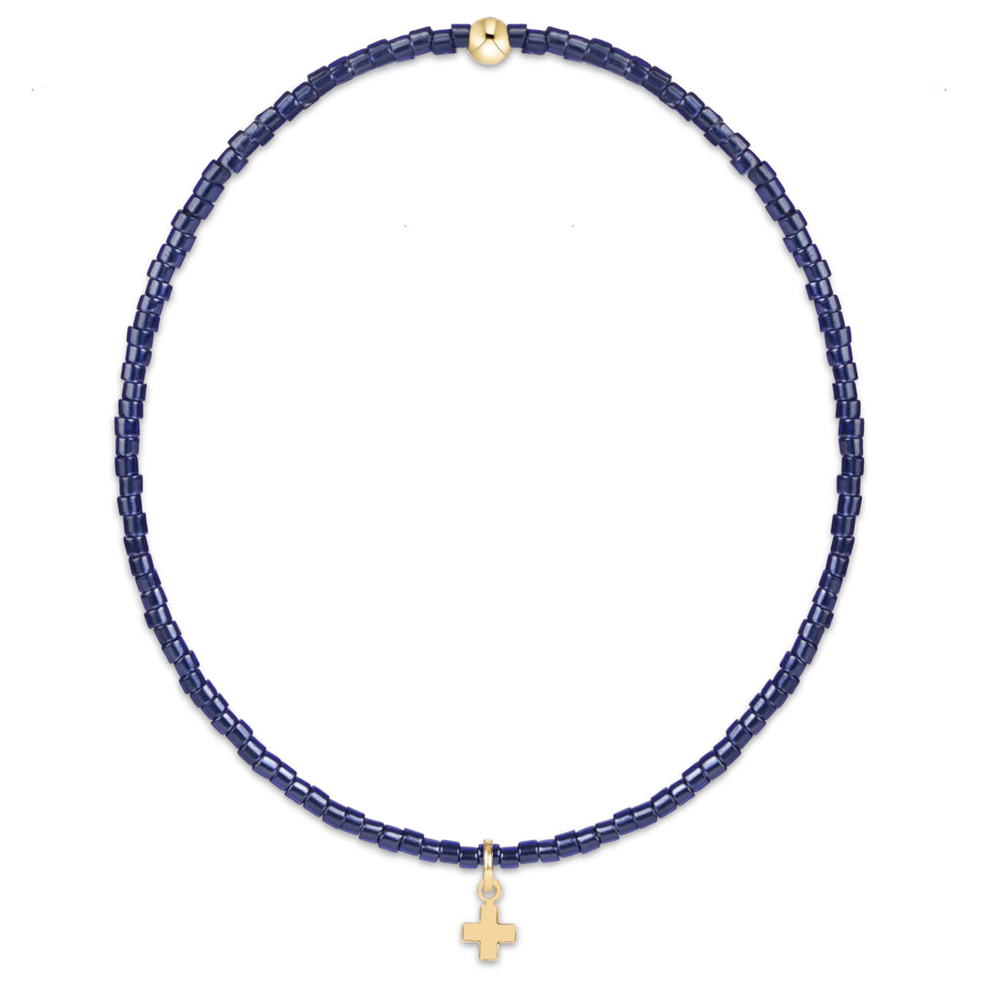 NAVY BEADED BRACELET WITH SMALL GOLD CROSS CHARM