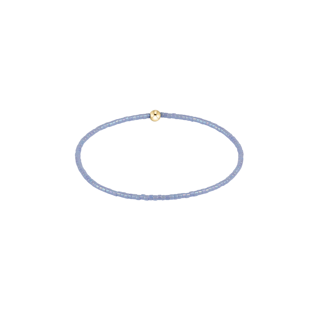 blue grey beaded bracelet with gold accent bead