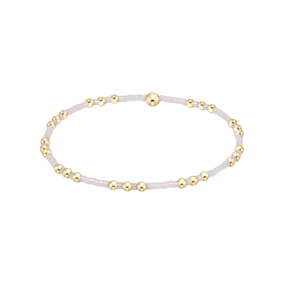 Bracelet with gold beads on a white background
