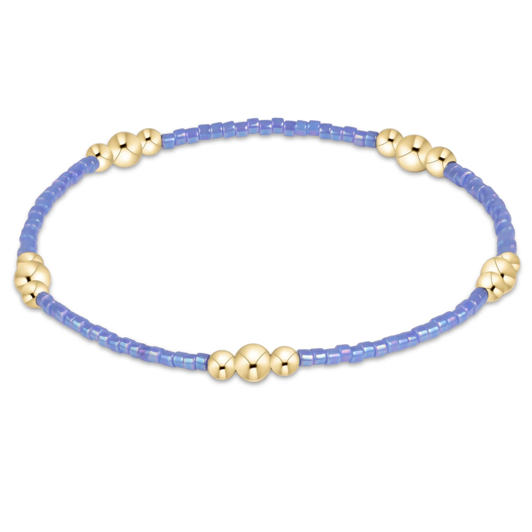 bright blue beaded bracelet with gold beads in clusters of three