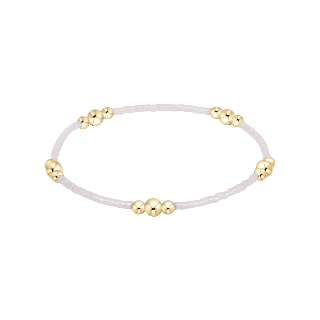 Bracelet with gold beads on a white background