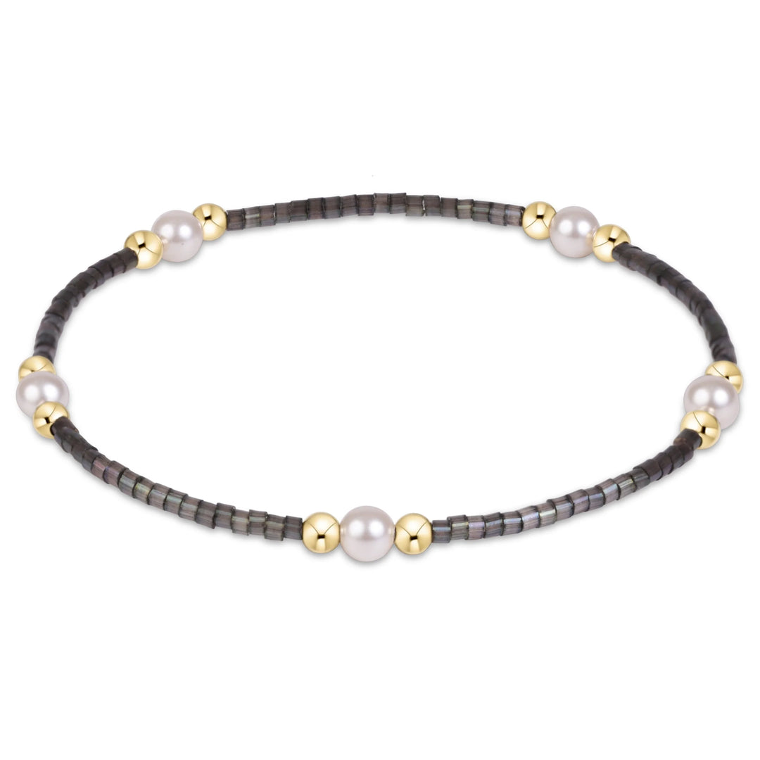 GRAY BEADED BRACELET WITH GOLD AND PEARL CLUSTERS ON WHITE BACKGROUND