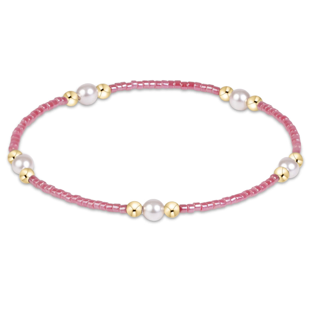 pink beaded bracelet with pearl and with gold beads in clusters of three