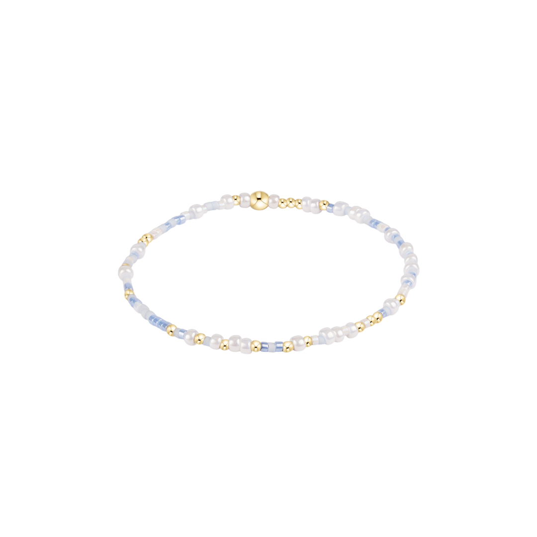 blue and white beaded bracelet with gold accents