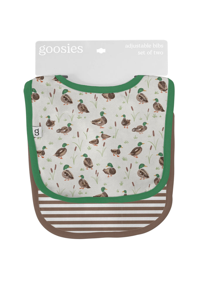 Baby bib with duck pattern and green border, packaging visible