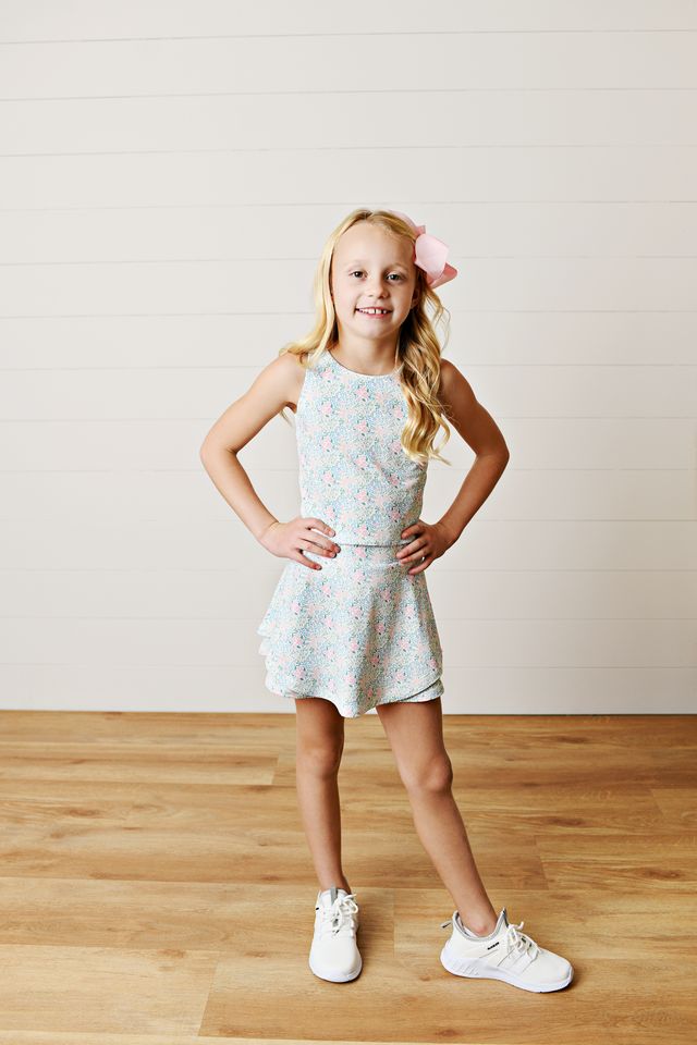 Allover ditsy floral bloom print
Two-piece tank top and; skort set on blonde little girl