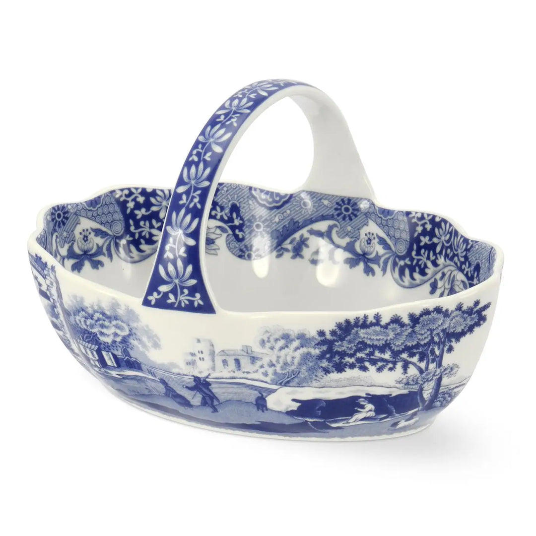 Blue and white ceramic basket with handle on a white background