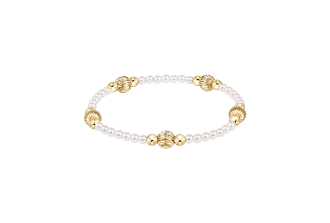 Pearl and gold bracelet on a white background