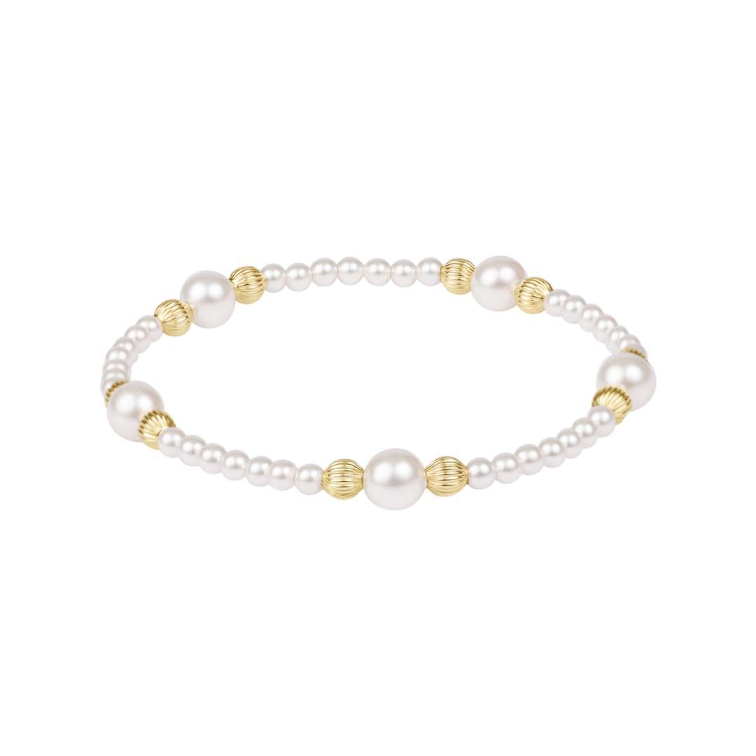 Pearl bracelet with gold beads on a white background