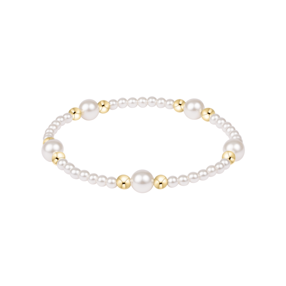 Pearl bracelet with gold accents on a white background