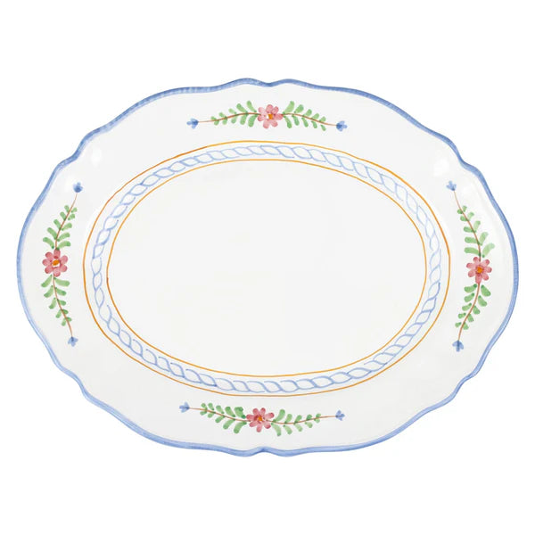 Decorative plate with floral and leaf patterns on a white background