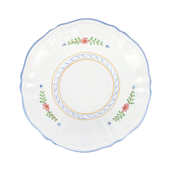 Decorative plate with floral and leaf patterns on a white background
