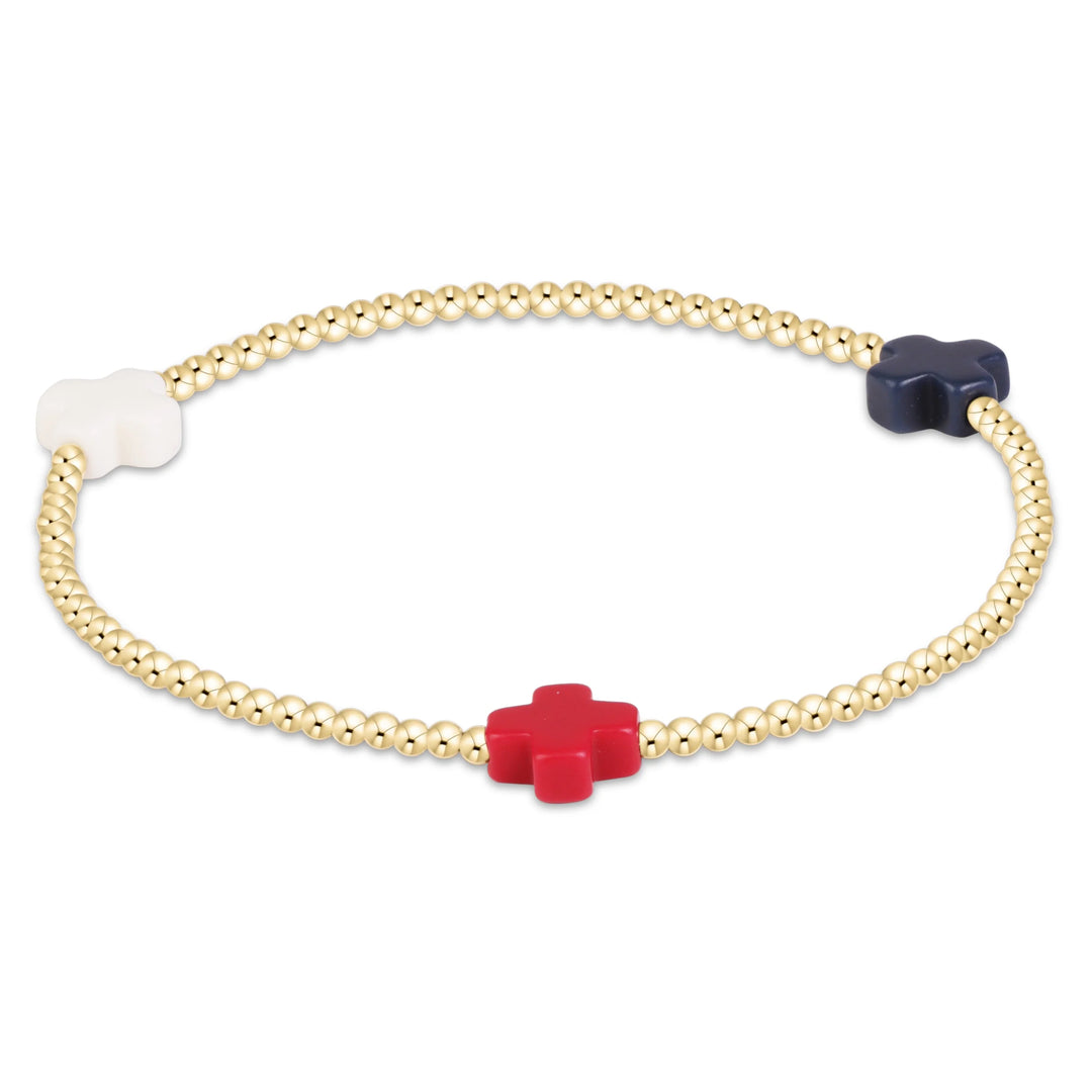 Gold beaded bracelet with red white and blue cross beads on a white background